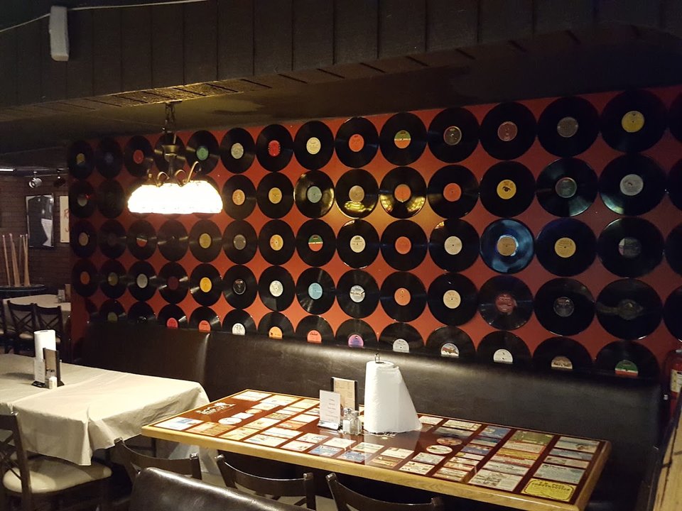 Casual dining room with burger plates and beer glasses.
