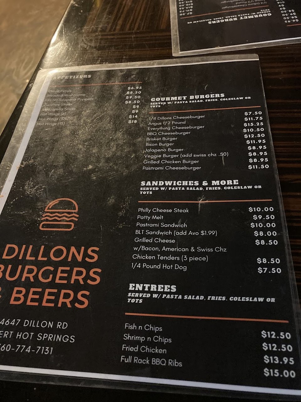 American restaurant menu beside cold beer selections.